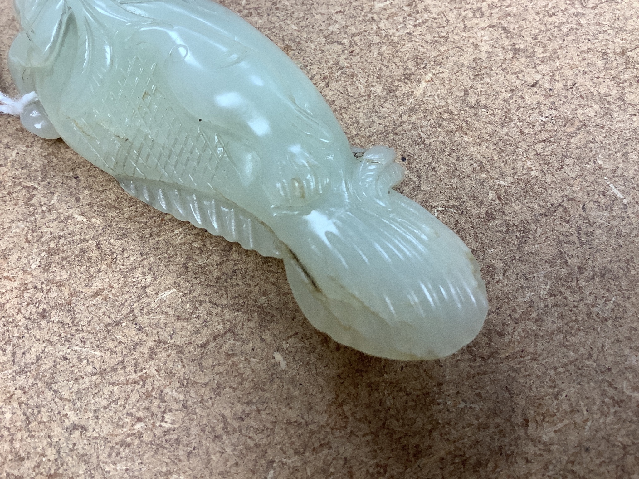 A Chinese pale celadon jade carving of a fish, 8.7 cm